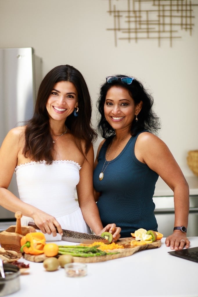 Monica Hidalgo and Dr. Aruna Nammi preparing a colorful spread of fruit and vegetables
